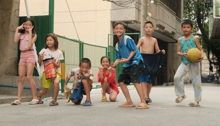 Filipino kids playing with a ball on a Manila street